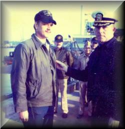 Captain Meier awarding Gene his good conduct medal