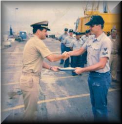 Captain Greene presenting Gene with CO's Letter of Commendation